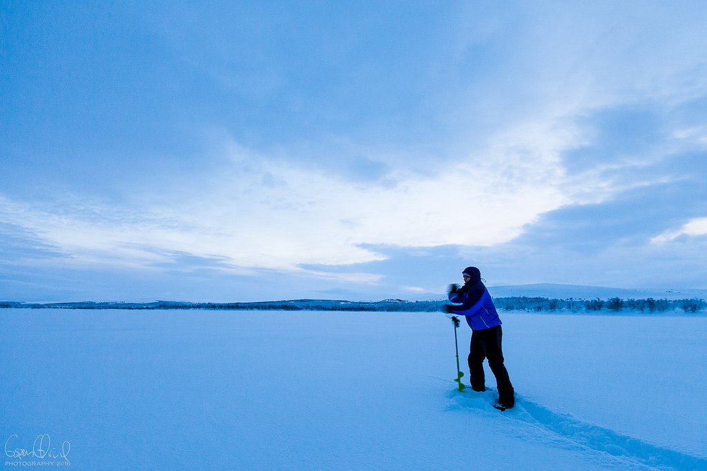 Drilling a hole in the ice